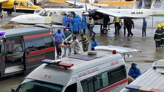 An injured child arrives on a plane at Georgetown Airport on May 22, 2023.