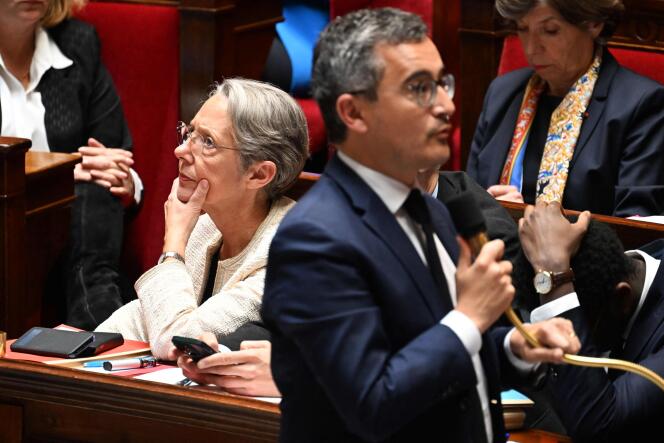 Elisabeth Borne and the Minister of the Interior and Overseas, Gérald Darmanin, during the session of questions to the government at the National embly, in Paris, on May 16, 2023. 