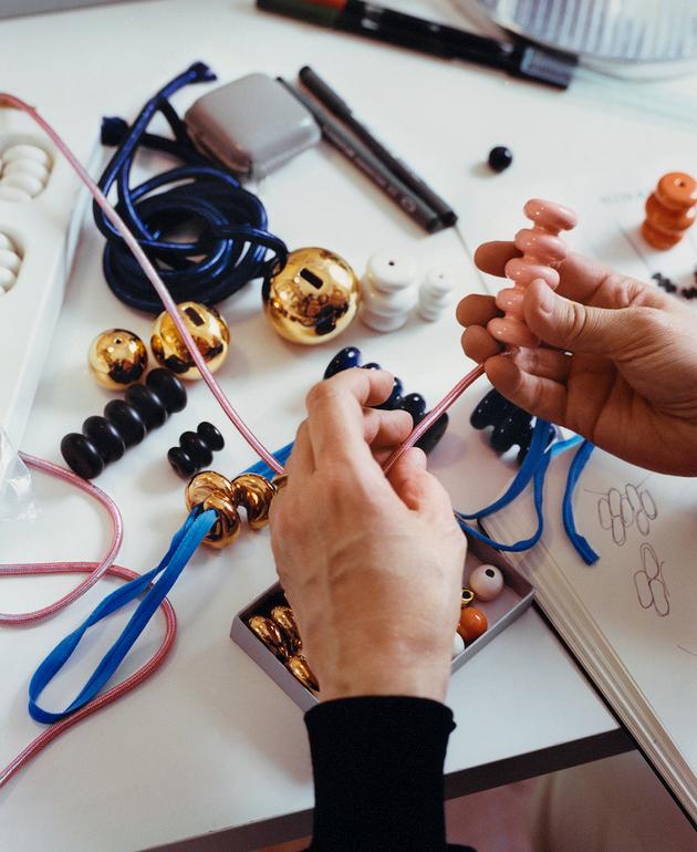 The jeweler is experimenting with compositions for her Eccola collection in enamelled ceramic beads.