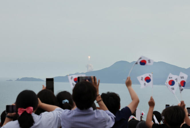 South Koreans watch the Noor rocket lift off in Goheung, South Korea, on May 25, 2023.