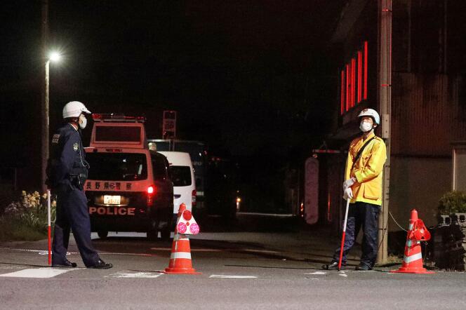 Police officers stand guard near the scene of a standoff where a suspect, believed to be a farmer in his 30s, was holed up inside a building in the Ebe area of ​​Nakano, Nagano Prefecture, late on May 25, 2023.
