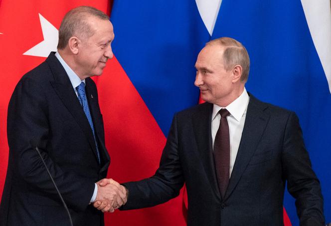 In this file photo taken on March 05, 2020 Russian President Vladimir Putin and his Turkish counterpart Recep Tayyip Erdogan shake hands following their talks at the Kremlin in Moscow.