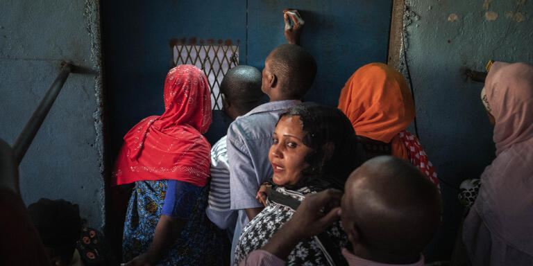 A group of people waiting to enter or receiving someone outside a gate that’s normally opened, but because some of the ferry passengers arriving have been deported in Operation Wuambushu on Mayotte island the gate is closed, Mutsamudu on Anjouan island in Comoros May 22th 2023.