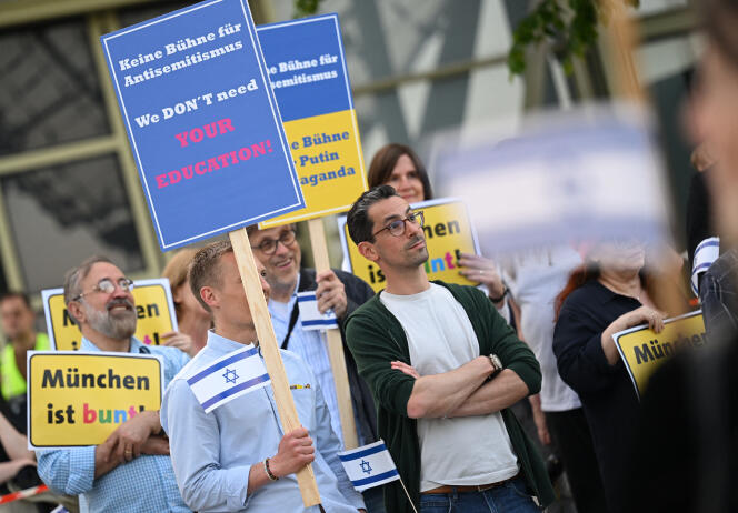 People demonstrate outside Munich's Olympiahalle ahead of a concert by Pink Floyd co-founder Roger Waters on May 21, 2023. The sign reads 'No stage for anti-Semitism - We don't need your education!  “, in reference to the flagship title of the group.