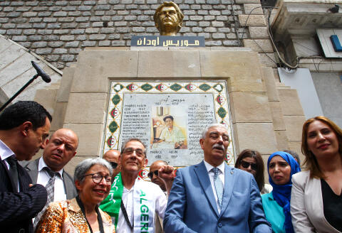 Pierre Audin (C-L), son of French mathematician and communist activist Maurice Audin, gestures during the inauguration of a bust of his father in central Algiers' "Place Maurice-Audin" on June 6, 2022. Pierre, a mathematician like his father, now retired, has just obtained his Algerian passport after a long wait. He has been in Algeria since the end of May, where he attended on Sunday the inauguration of a bust bearing the likeness of his father in the square that bears his name in the heart of the capital and which was the epicenter of Hirak, the pro-democracy protest movement that forced ex-president Abdelaziz Bouteflika to resign. (Photo by AFP)
