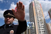A policeman secures an area in front of a building damaged after a drone attack in Moscow, Russia, on May 30, 2023.