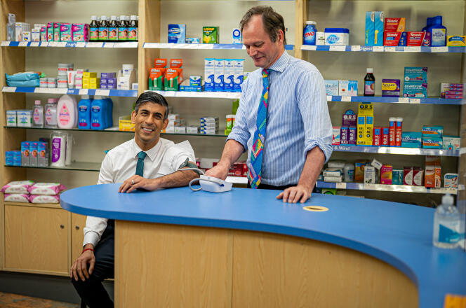 Britain's Prime Minister Rishi Sunak has his blood pressure checked by a pharmacist, in Weston, southern England, May 9, 2023.