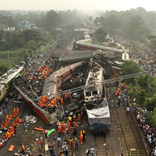 A drone shot of rescuers work at the site of passenger trains accident, in Balasore district, in the eastern Indian state of Orissa, Saturday, June 3, 2023. Rescuers are wading through piles of debris and wreckage to pull out bodies and free people after two passenger trains derailed in India, killing more than 280 people. Hundreds of others were trapped inside more than a dozen mangled rail cars, in one of the country's deadliest train crashes in decades. (AP Photo/Arabinda Mahapatra)