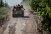 Ukrainian soldiers riding an M113 armored personnel carrier near the town of Bakhmut, Donetsk region, June 9, 2023.