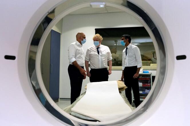 Former UK Prime Minister Boris Johnson (C), former UK Health Secretary Sajid Javid (L) and former Chancellor of the Exchequer Rishi Sunak (R) during a visit to the new Queen Elizabeth II Hospital in Welwyn Garden City, north London, on April 6, 2022.
