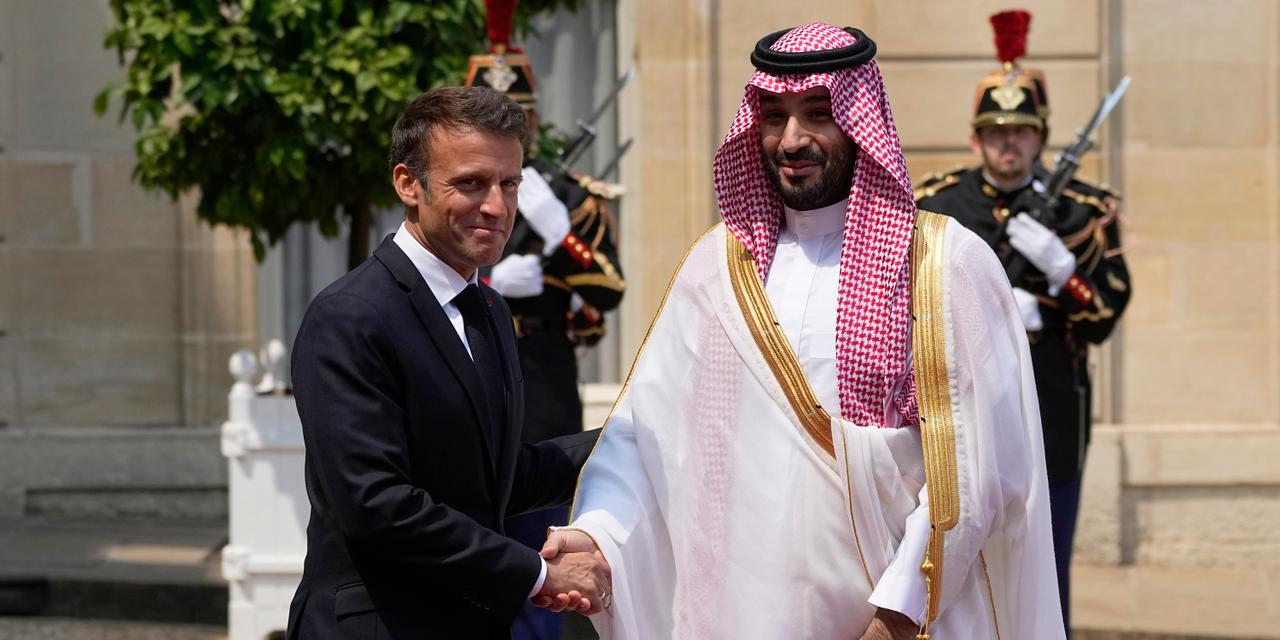 Saudi Crown Prince Mohammed bin Salman is welcomed by French President Emmanuel Macron, Friday, June 16, 2023 at the Elysee Palace in Paris. Saudi Crown Prince Mohammed bin Salman meets Emmanuel Macron as part of an official visit, during which he will also participate in a global financing summit aimed at fighting poverty and climate change. (AP Photo/Michel Euler)
