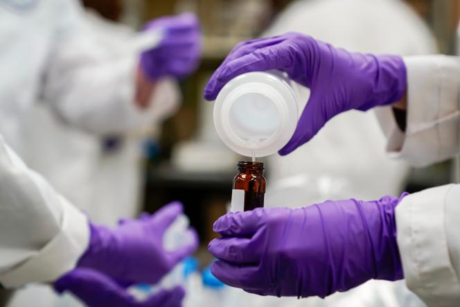 Eva Stebel, water researcher, pours a water sample into a smaller glass container for experimentation as part of drinking water and PFAS research at the US Environmental Protection Agency Center for Environmental Solutions and Emergency Response on February 16, 2023, in Cincinnati. 