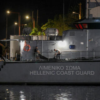 Men transfer body bags carrying migrants who died after their boat capsized in the open sea off Greece, onboard a Hellenic Coast Guard vessel at the port of Kalamata, Greece, June 14, 2023. REUTERS/Stelios Misinas