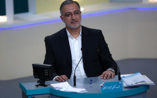 This handout photo made available by the Iranian Young Journalist Club (YJC) shows Iran's presidential candidate Alireza Zakani during the third televised debate ahead of the June 18 election, at the Iran State television studio in Tehran on June 12, 2021. (Photo by MORTEZA FAKHRI NEZHAD / YJC NEWS AGENCY / AFP) / RESTRICTED TO EDITORIAL USE - MANDATORY CREDIT "AFP PHOTO /IRANIAN YOUNG JOURNALIST CLUB (YJC) " - NO MARKETING - NO ADVERTISING CAMPAIGNS - DISTRIBUTED AS A SERVICE TO CLIENTS