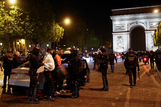 Police detain young people during protests following the death of Nahel, a 17-year-old teenager killed by a French police officer in Nanterre during a traffic stop, in the Champs Elysees area, in Paris, France, July 2, 2023.