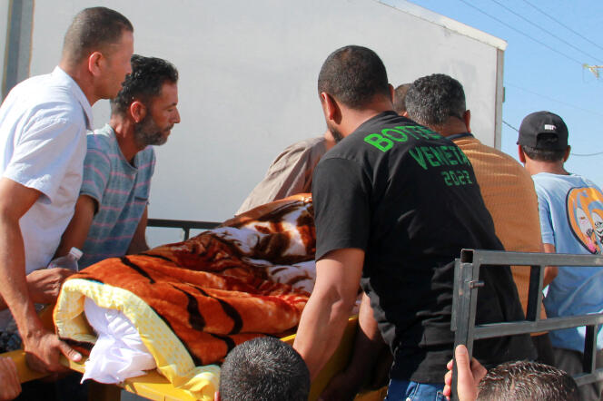 Los tunecinos llevan el cuerpo de un hombre muerto por un cuchillo en las calles de Sfax.  4 de julio de 2023.
