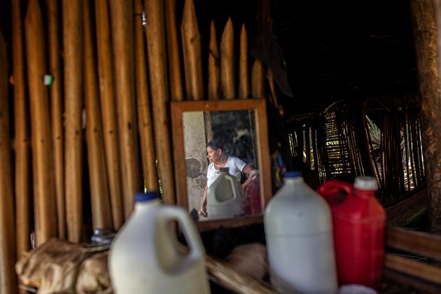 Briseida Geronimo, 50, at home in Guareruche, Guatemala, on June 22, 2023. She uses her jerry cans to collect water from the nearest spring, several kilometers away.