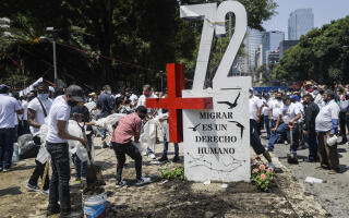 Activists place an "anti-monument" to mark the 10th anniversary of the San Fernando Massacre in which 72 migrants on route to the United States were killed in the Mexican state of Tamaulipas, in front of the US embassy in Mexico City, on August 22, 2020. August 24, 2020 marks the 10th anniversary of the San Fernando massacre in which 72 migrants were killed by the Zetas drug cartel for allegedly refusing to work for the cartel. (Photo by Pedro PARDO / AFP)