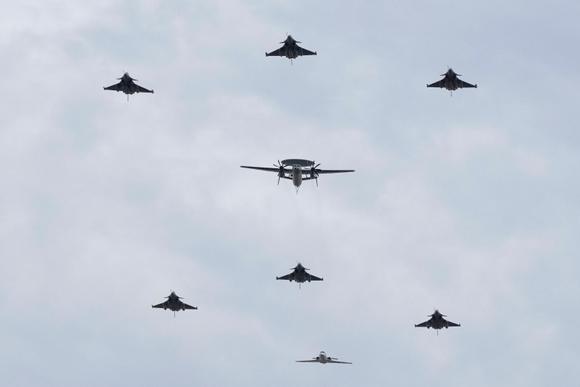 Des avions militaires, parmi lesquels un AWAC, survolent l’avenue des Champs-Elysées lors du défilé du 14-Juillet, à Paris, le vendredi 14 juillet 2023.