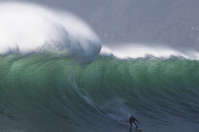 A surfer catches a wave in Cape Town, South Africa, in August 2022.