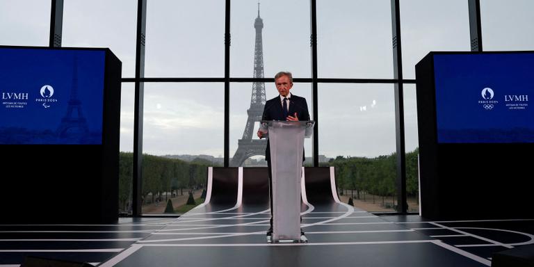 PASCAL ROSSIGNOL / REUTERS Bernard Arnault, Chairman and Chief Executive Officer of LVMH Moet Hennessy Louis Vuitton, speaks during a press conference to announce a LVMH sponsorship deal for the Paris 2024 Olympic Games at the Grand Palais Ephemere, with the Eiffel Tower in the background, in Paris, France, July 24, 2023. REUTERS/Pascal Rossignol