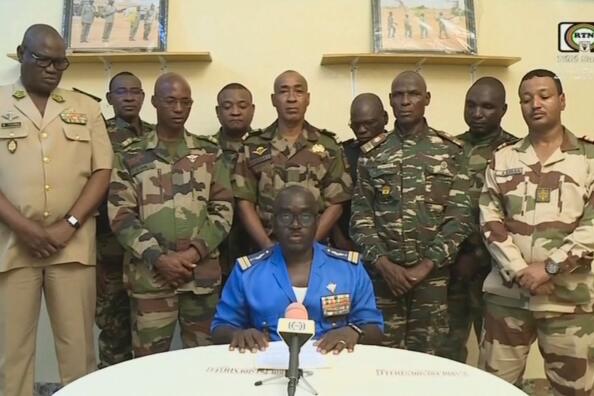 This video frame grab image obtained by AFP from ORTN - Télé Sahel on July 26, 2023 shows Colonel Major Amadou Abdramane (C), spokesperson for the National Committee for the Salvation of the People (CNSP) speaking during a televised statement. Soldiers claimed on July 26, 2023 to have overthrown the government of Niger President Mohamed Bazoum in a statement read out on national television, after a day in which the leader was detained in his official residence.
"We, the defence and security forces... have decided to put an end to the regime" of President Bazoum, said Colonel-Major Amadou Abdramane, surrounded by nine other uniformed soldiers in the address. They said "all institutions" in the country would be suspended, borders were closed, and a curfew had been imposed "until further notice". (Photo by ORTN - TéLé SAHEL / AFP)