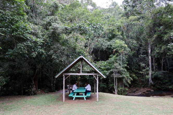 Papua New Guinea Prime Minister James Marape talks with French President Emmanuel Macron during a visit to Varirata National Park near Port Moresby, on July 28, 2023.