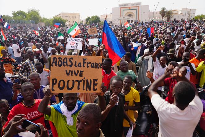 Nigeriens participate in a march called by supporters of coup leader Gen. Abdourahmane Tchiani in Niamey, Niger, Sunday, July 30, 2023.