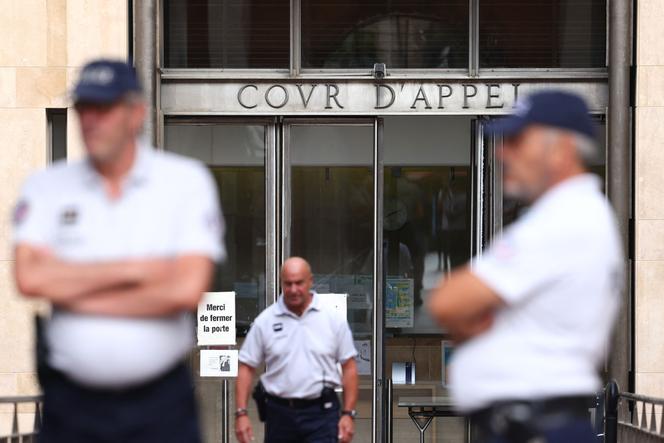 French police officers stand at the entrance of the Courtroom in Aix-en-Provence on August 3, 2023.