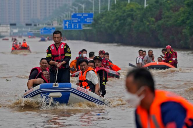 Residents evacuate on rubber boats through floodwaters in Zhuozhou in northern China's Hebei province, south of Beijing, Wednesday, Aug. 2, 2023. 