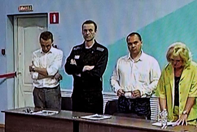 A screen shows the already imprisoned Russian opposition figure Alexei Navalny as he listens to his verdict over a series of extremism charges at the IK-6 penal colony, a maximum-security prison some 250 kilometers east of Moscow, in the settlement of Melekhovo in the Vladimir region on August 4, 2023.