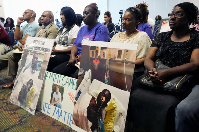 The families of Michael Corey Jenkins and Damien Cameron sit together during the Justice Department's Civil Rights Division tour Thursday, June 1, 2023, in Jackson, Miss. 