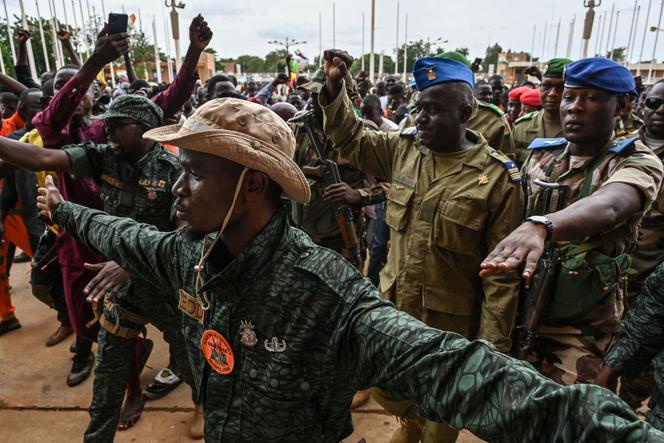 Members of the National Council for the Safeguard of the Homeland (CNSP) are greeted by supporters as they arrive at the Seyni-Kountché Stadium in Niamey, on August 6, 2023.