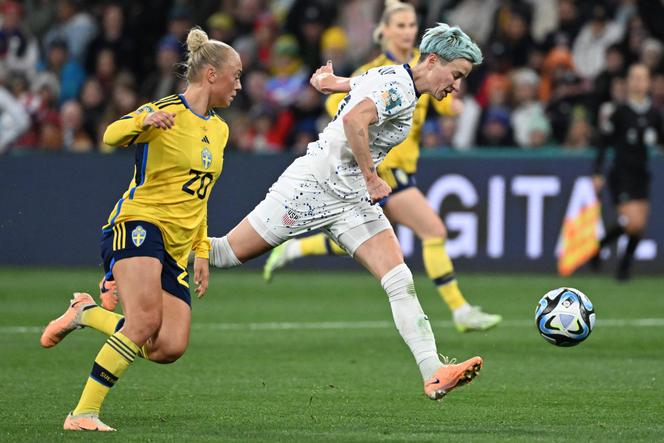 US forward #15 Megan Rapinoe (right) is challenged during the Australia and New Zealand 2023 Women's World Cup round of 16 football match between Sweden and the United States at Melbourne Rectangular Stadium in Melbourne on August 6, 2023.