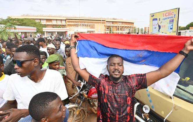 Supporters of Niger's National Council for the Safeguard of the Homeland (CNSP) wave a Russian flag as they demonstrate in Niamey on August 6, 2023.