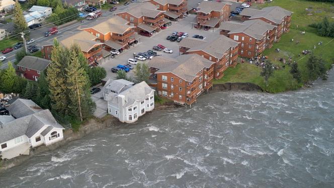A drone view shows a house collapsing into a river due to glacial floods in Juneau, Alaska, on August 5, 2023. 