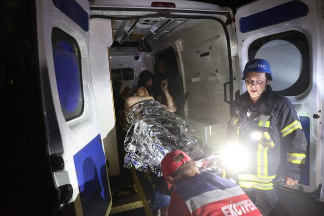 Rescuers carry a wounded person into an ambulance following Russian missiles strikes in Pokrovsk, Donetsk region, amid Russian invasion of Ukraine, on August 7, 2023.