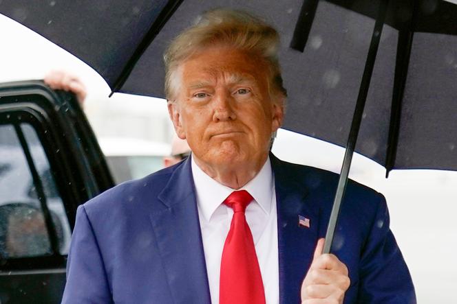 Former President Donald Trump walks to speak with reporters before boarding his plane at Ronald Reagan Washington National Airport, on August 3, 2023, in Arlington, Va.