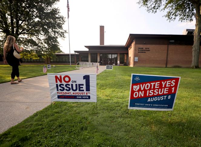 Opposing signs on Issue 1 are posted outside the polling site at Toth Elementary School, Tuesday, Aug. 8, 2023, in Perrysburg, Ohio.