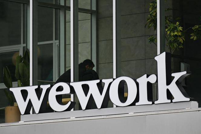 The WeWork logo is displayed outside of an office space rental location in Santa Monica, California on March 20, 2023.