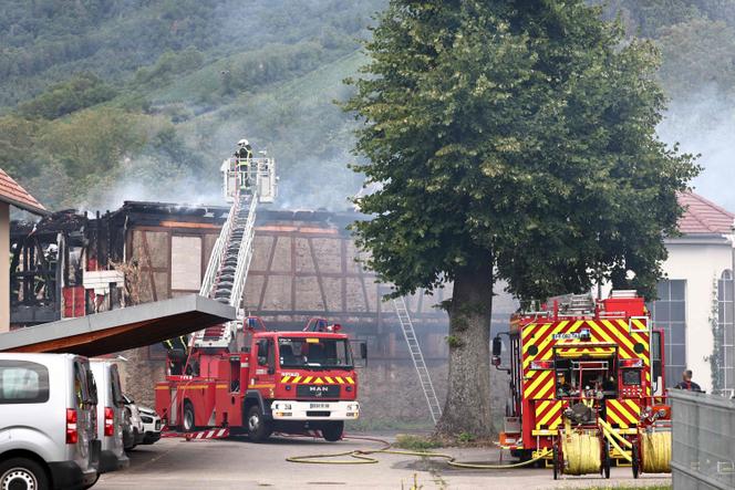 Firefighters work to extinguish a fire that erupted at a home for disabled people in Wintzenheim near Colmar, eastern France, on August 9, 2023.