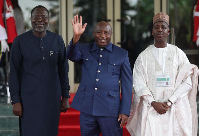 President of Economic Community of West African States Commission Omar Touray (L), Burundi's President Evariste Ndayishimiye (C) and Nigerian Foreign Affairs Minister Adamu Ibrahim Lamuwa (R) pose for a photograph at the Economic Community of West African States (ECOWAS) Head of States and Government extraordinary session in Abuja on August 10, 2023.