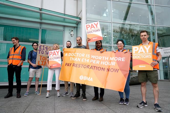 Junior doctor members of the British Medical Association (BMA) stand on the picket line outside University College London Hospital (UCLH) at the start a four-day strike amid the bitter dispute with the Government over pay, in London, Friday Aug. 11, 2023.