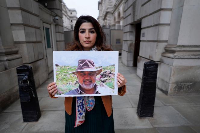 Roxanne Tahbaz holds a photo of her father Morad Tahbaz, imprisoned in Iran. London, April 13, 2022.