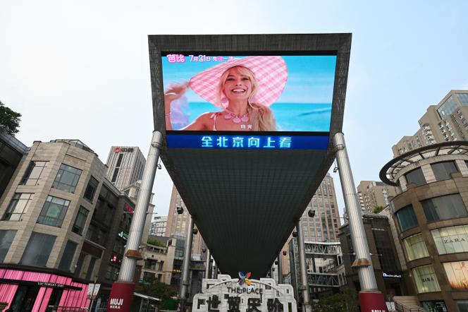The trailer for the 'Barbie' film is shown on a giant screen outside a shopping mall in Beijing on July 20, 2023.
