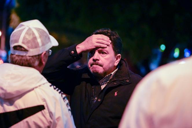 A man reacts after the assassination of Fernando Villavicencio as he left a campaign rally outside a school in Quito, Ecuador, Wednesday, August 9, 2023.