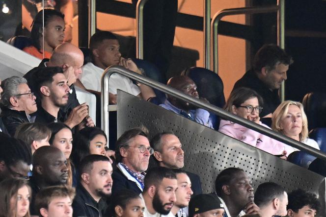 Kylian Mbappé sits in the stand during Paris Saint-Germain's opening match against Lorient at the Parc des Princes Stadium in Paris on August 12, 2023.