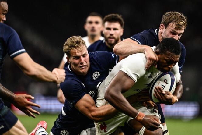 France's flanker Cameron Woki (C) is tackled by Scotland's wing Duhan van der Merwe (L) and Scotland's lock Richie Gray (R) during the pre-World Cup Rugby Union friendly match between France and Scotland at the Geoffroy-Guichard Stadium in Saint-Etienne, southeastern France, on August 12, 2023.