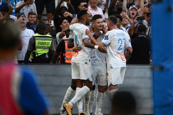 Marseille's Portuguese forward #09 Vitor Manuel Carvalho De Oliveira (C) celebrates with teammates after scoring his team's second goal during the French L1 football match between Marseille (Olympique de Marseille) and Reims at the Orange Velodrome stadium in Marseille, southern France, on August 12, 2023.