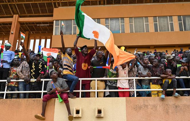  Supporters cheer from the stands as artists perform during a concert in support to Niger's National Council for the Safeguard of the Homeland (CNSP) at the General Seyni Kountche Stadium in Niamey on August 13, 2023. 